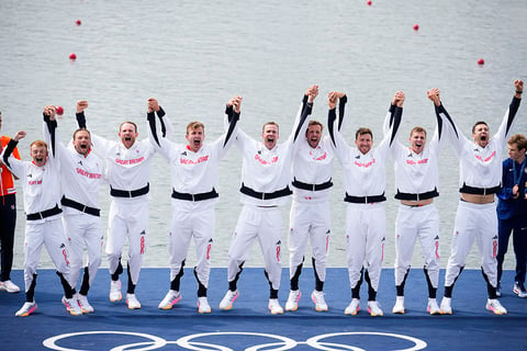 Men's eight rowing final: Britain team pose after winning gold 